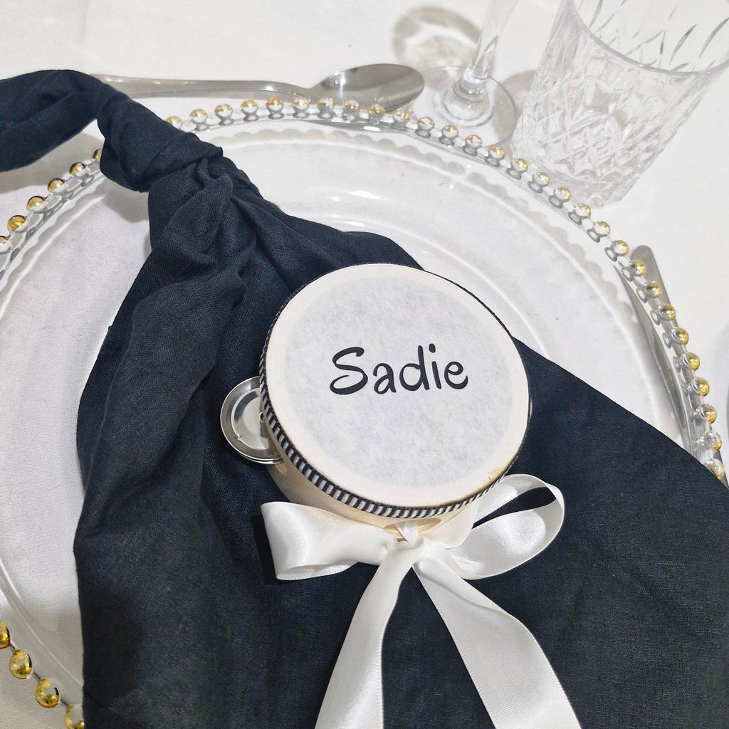 Napkin holder with 'Sadie' on a tambourine on a decorative table setting