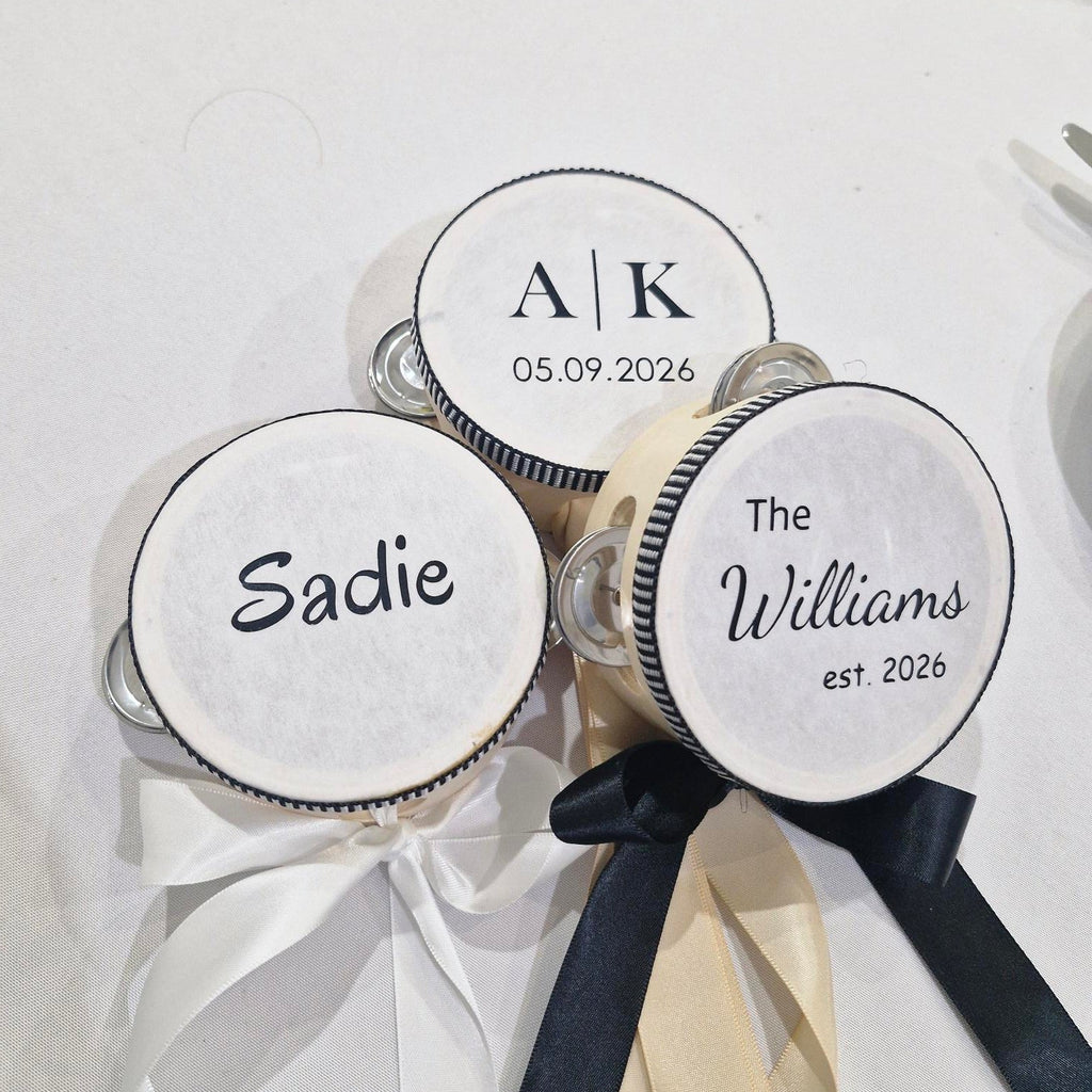 Personalised tambourines with names and dates on a white background