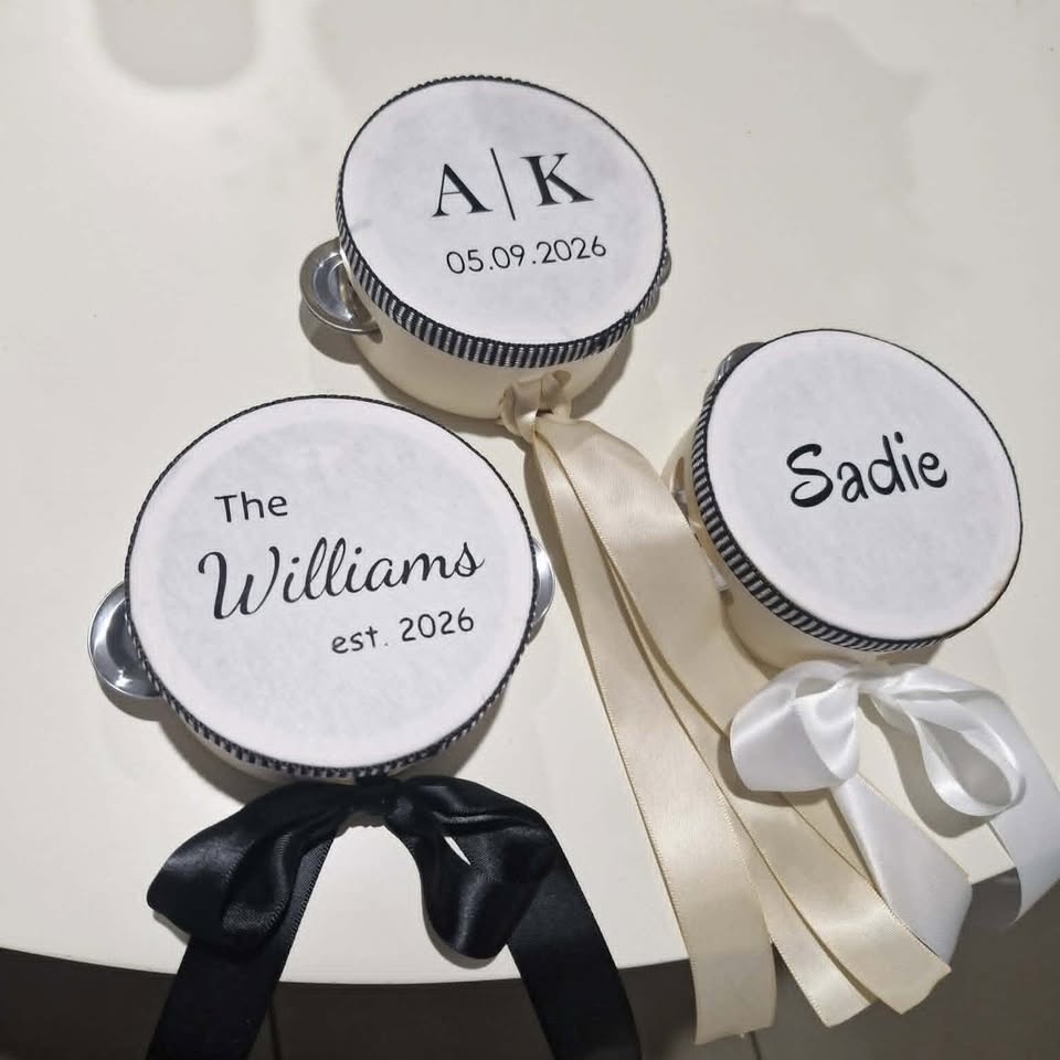Personalized tambourines with names and dates on a white background