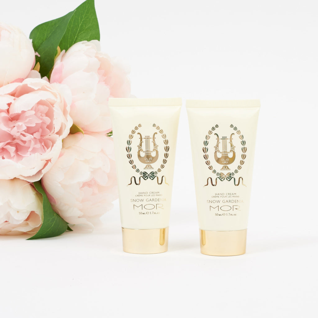 Two tubes of Mor hand cream with pink flowers on a white background