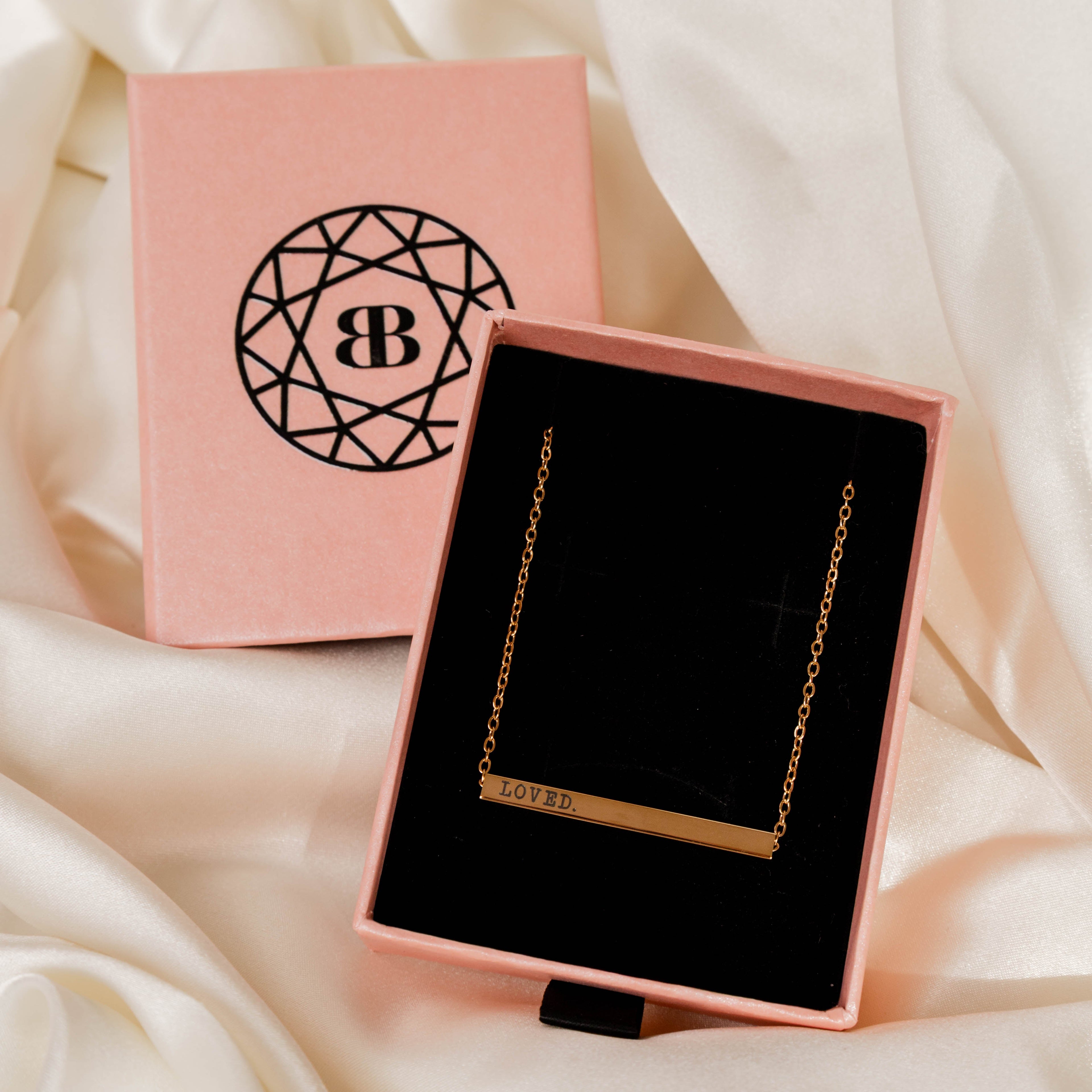 Jewellery box with a necklace on a soft fabric background