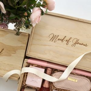 maid of honour wooden keepsake gift box with blush roses in the foreground and some hamper items visible under ivory ribbon