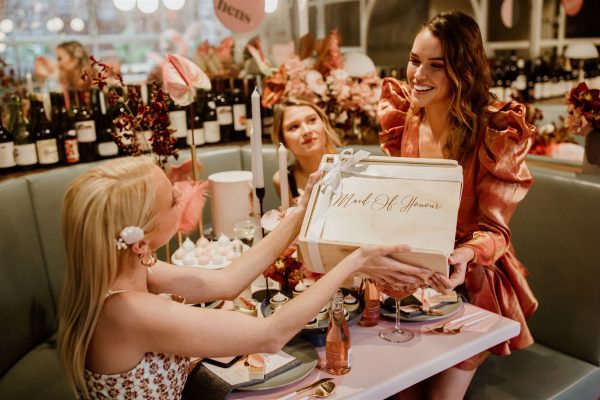 bride to be gifting her maid of honour a keepsake gift hamper at her bridal shower