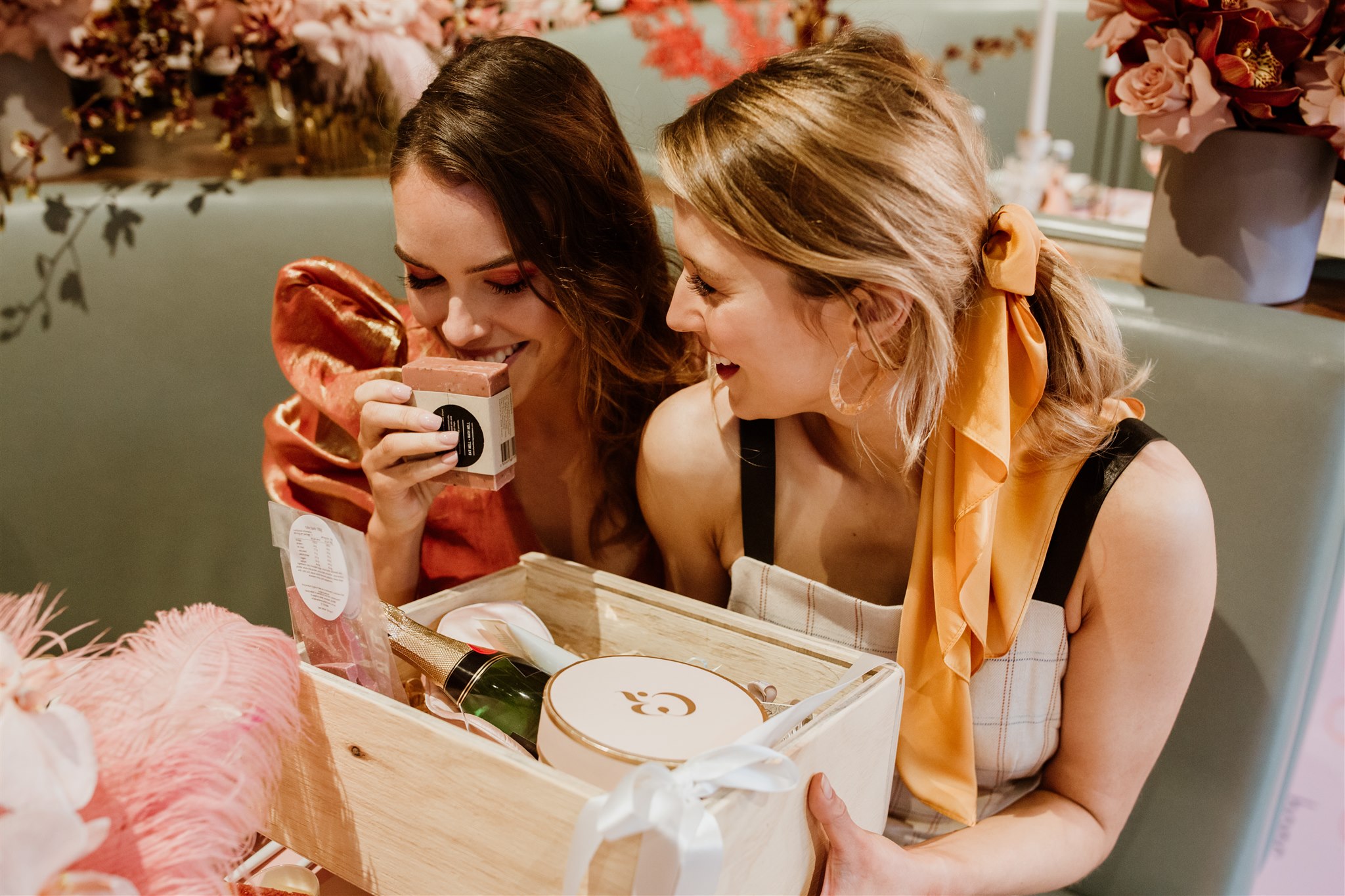 bridesmaids opening a keepsake hamper box and enjoying the gifts inside