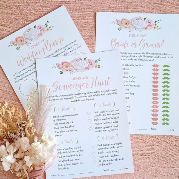 Hen's party game cards displayed with dried floral arrangement
