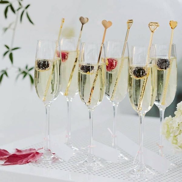 hearts and diamond cocktail stirrers in champagne