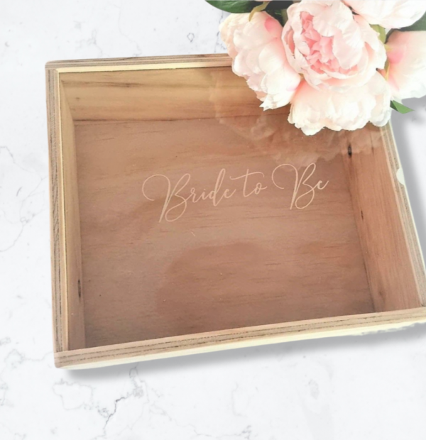 custom engraved acrylic lidded wooden box reading 'Bride to Be' on a marble floor