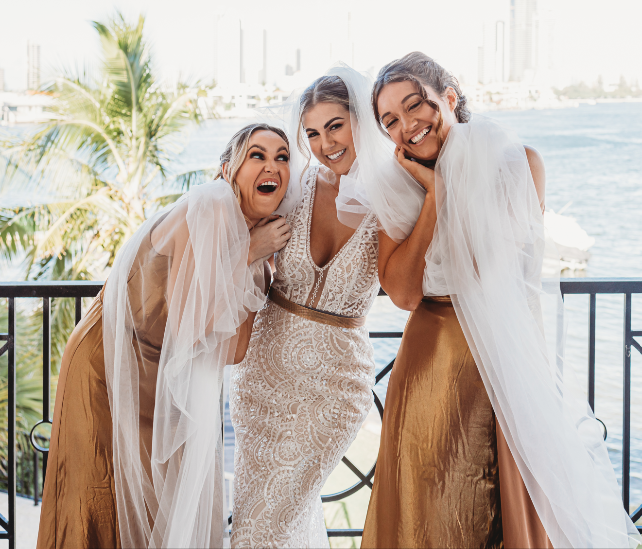 bridesmaids having fun in brides veil