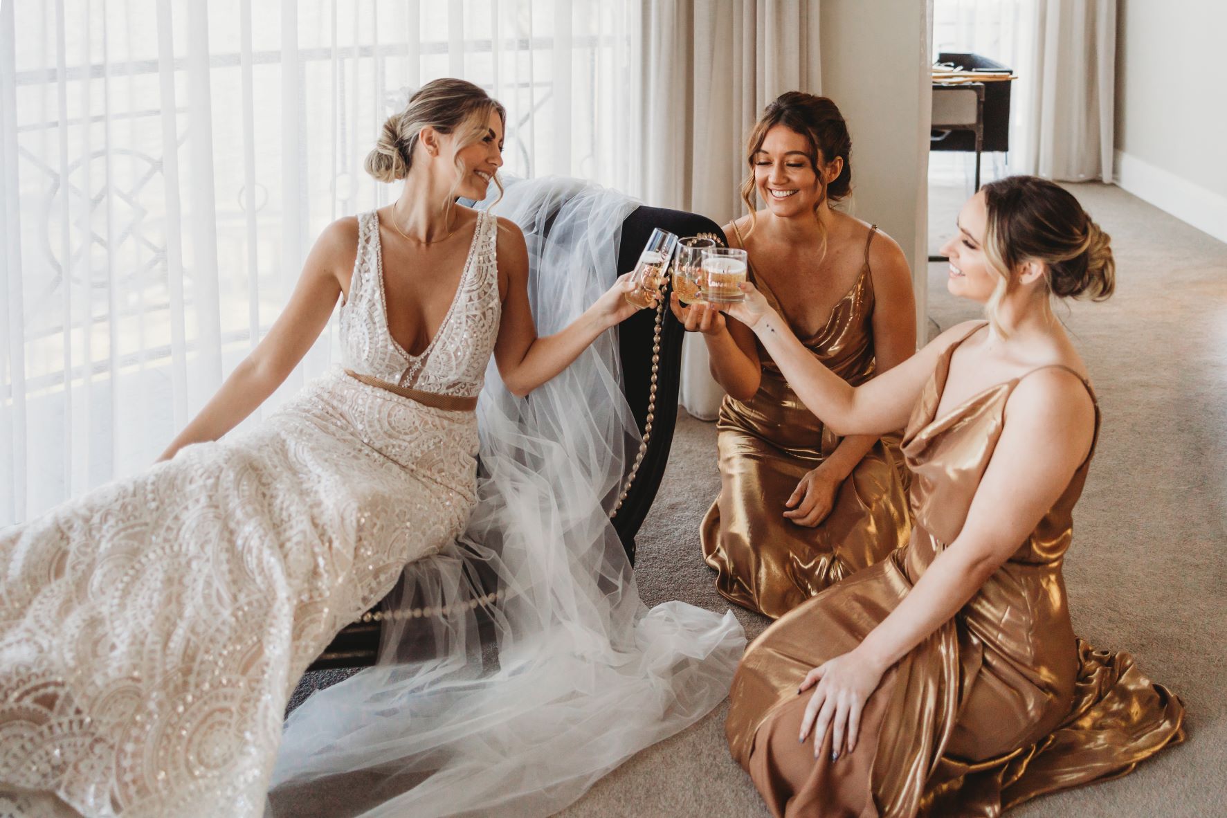 Bridesmaids and Bride clinking their champagne before wedding