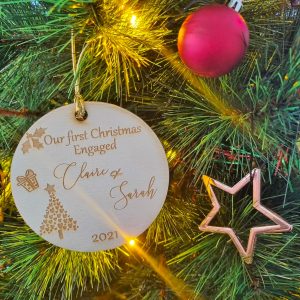 personalised wooden christmas ornament celebrating a couple's first christmas together as engaged