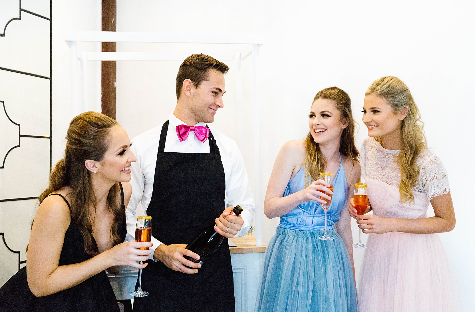 girls at a hen's party laughing with their personal butler
