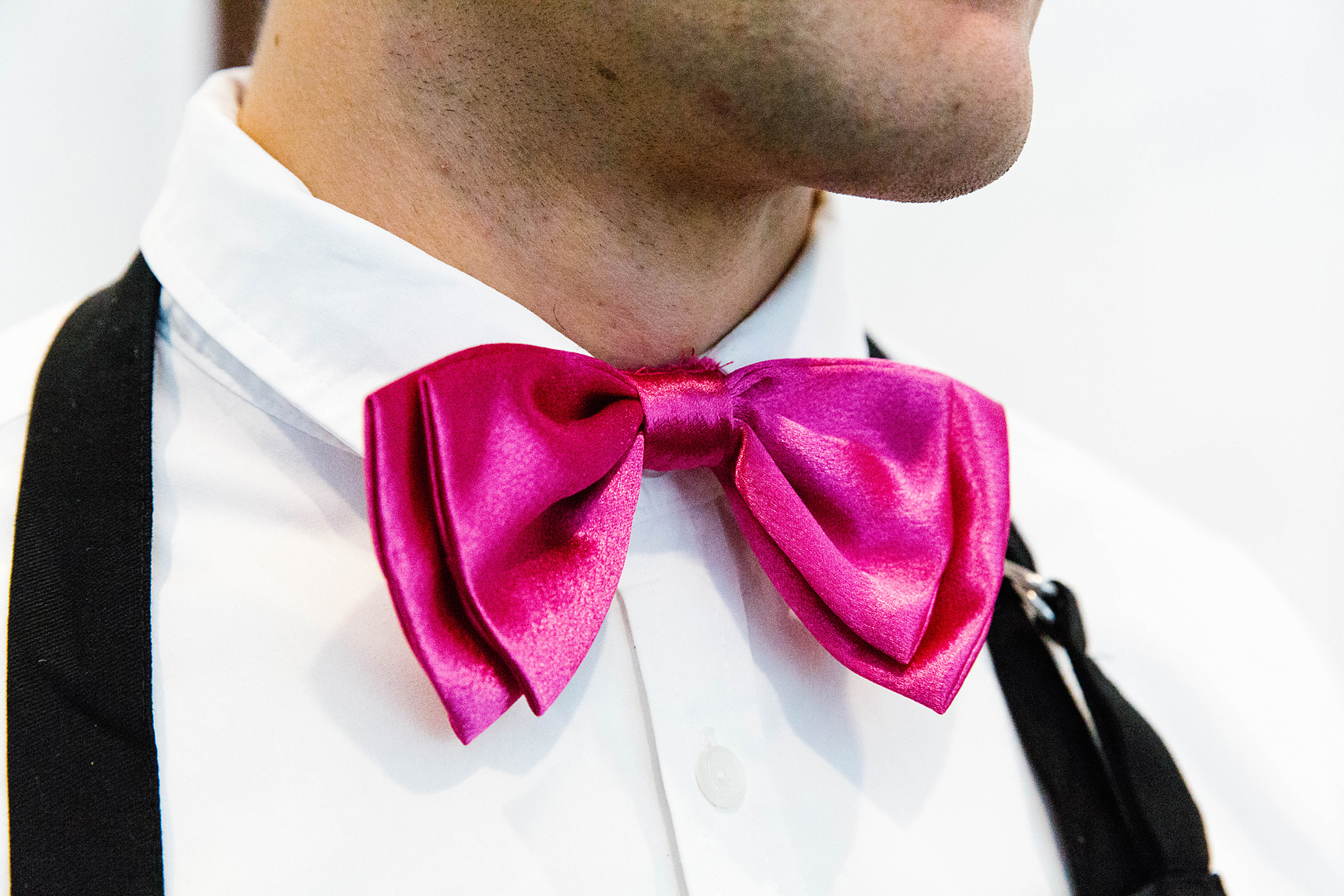 a close up of a pink man's bow tie