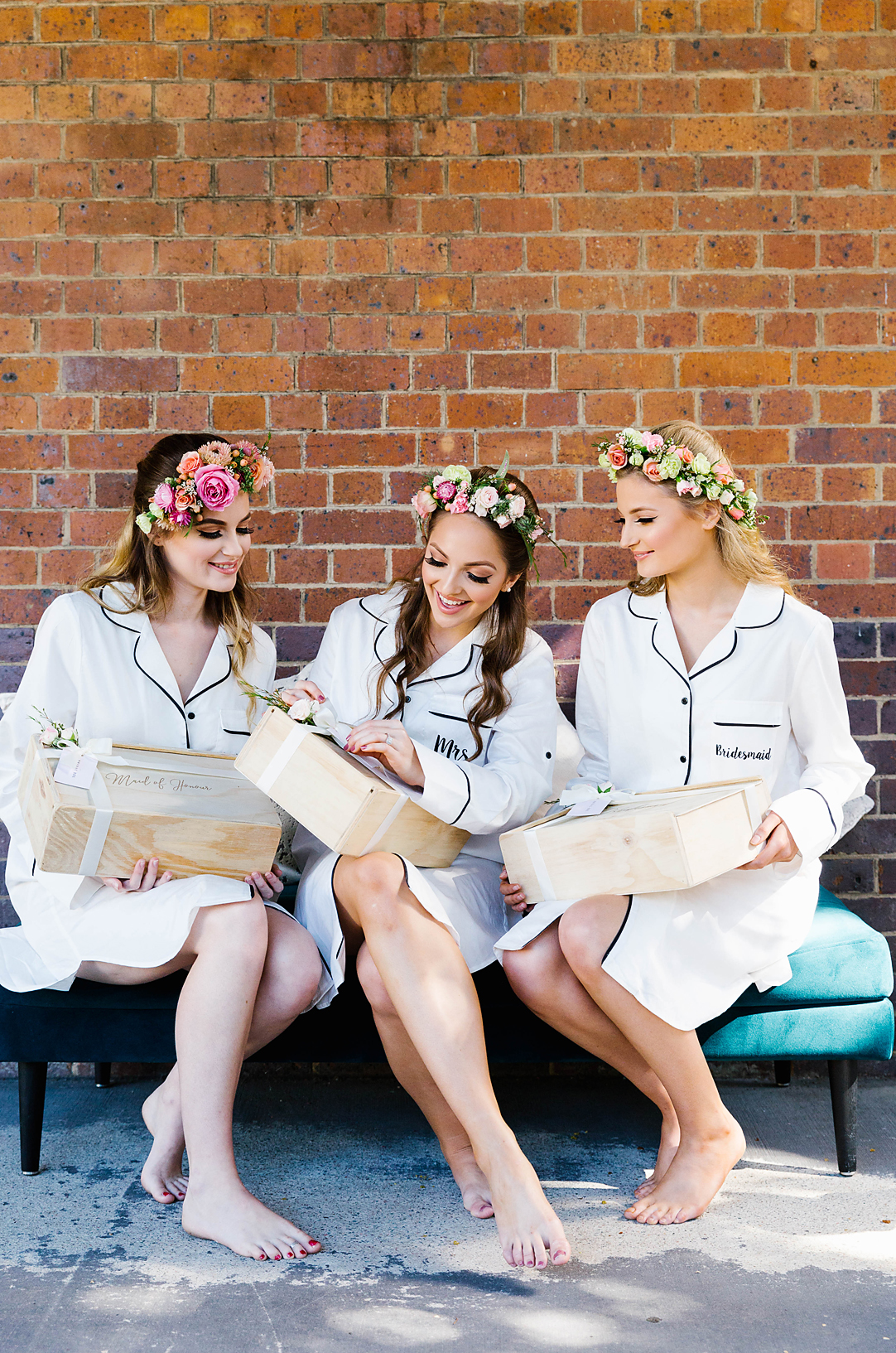 a bride to be and her bridesmaids are in matching pjs exchanging gift hampers during a hens party