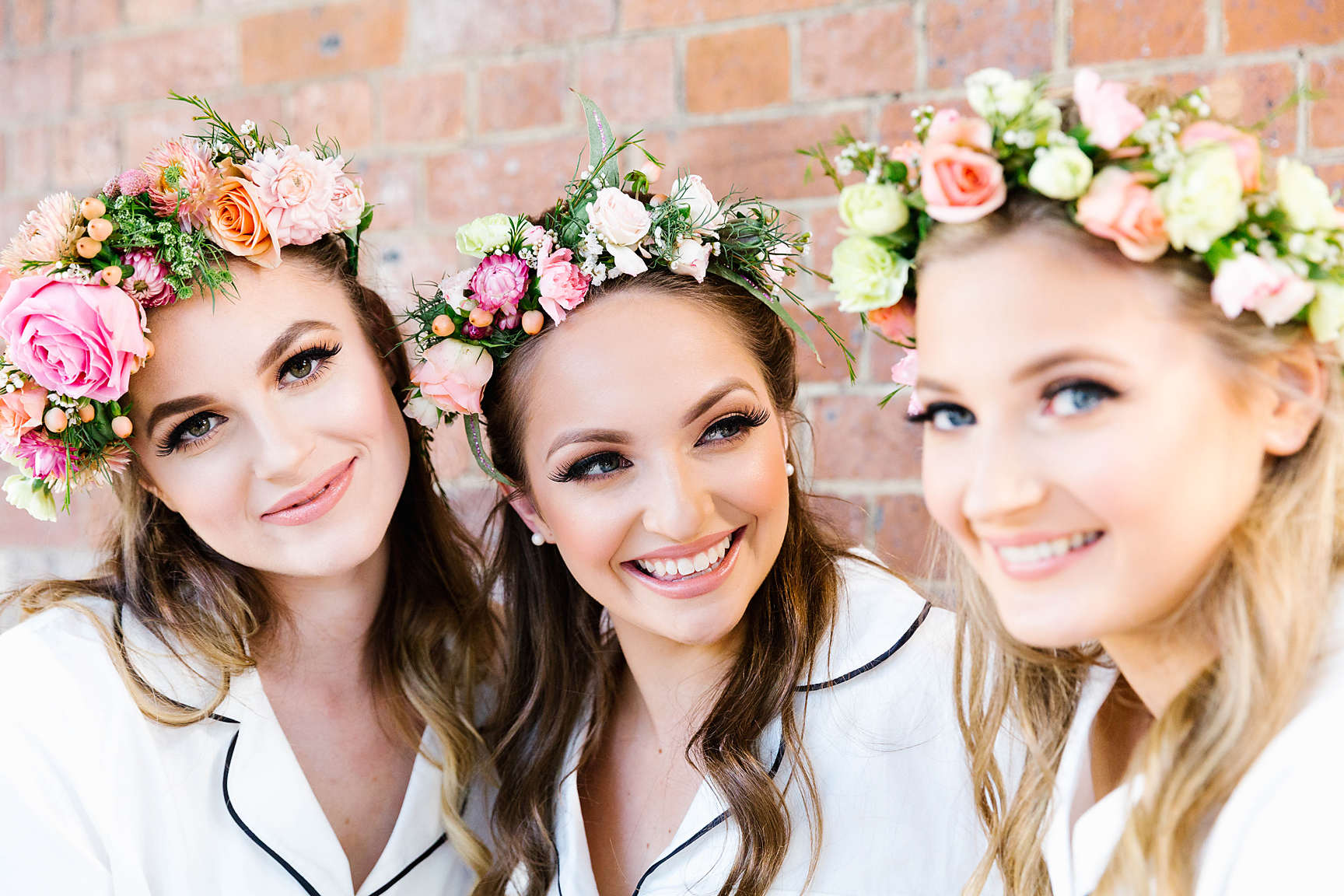bride to be with her bridesmaids smiling and wearing flower crowns