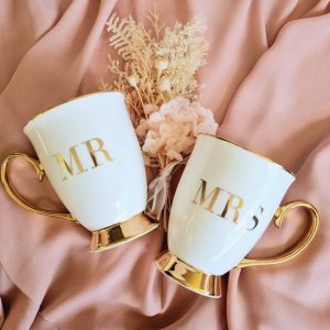 MR and MRS bone china mug with 18k gold embellishments on soft pink background with dried flower posey