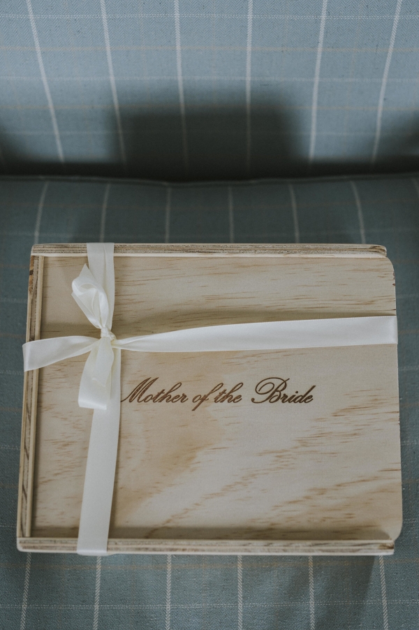 a large wooden keepsake giftbox with mother of the bride engraved on the lid and finished with an ivory ribbon