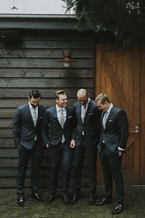 groom with his groomsmen, laughing and smiling