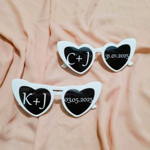 heart wedding sunglasses with white stickers on lenses with couples initials and wedding date. Replica of viral wedding reception photography.