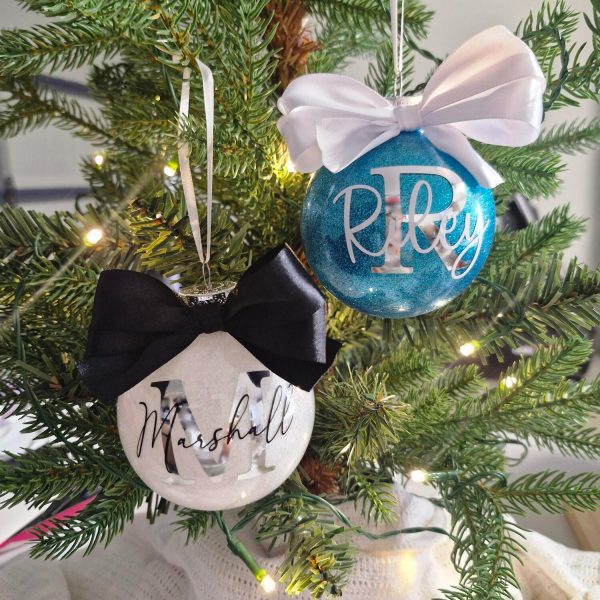 christmas baubles with bows hanging on christmas tree